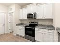 Modern kitchen with white cabinets, granite countertops, and stainless steel appliances at 1578 Doran Ter, Richburg, SC 29729