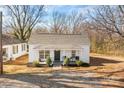 Charming single-story home featuring a covered front porch with seating and a well-maintained front yard at 19705 S Ferry St, Cornelius, NC 28031