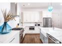 Bright kitchen featuring white cabinets, marble island, and farmhouse sink at 2002 Summey Ave # 3, Charlotte, NC 28205