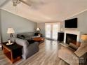 Living room with gray sofa, wood floors and a fireplace at 203 Shane Dr, Mount Holly, NC 28120