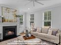 Cozy living room featuring a fireplace and large windows at 270 Gilead Rd, Huntersville, NC 28078