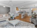 Open-concept living room showcasing the kitchen and hardwood floors at 270 Gilead Rd, Huntersville, NC 28078