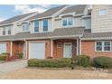 Brick front of townhome with attached garage and neatly landscaped area at 315 Valley Brook Se Ln, Concord, NC 28025