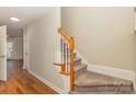 Wooden staircase with carpeted steps in a light-toned hallway at 315 Valley Brook Se Ln, Concord, NC 28025