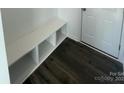 Built-in bench with storage in the entryway, featuring dark hardwood floors at 412 Catawba Ave, Davidson, NC 28036