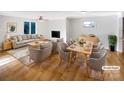 Virtually staged living room with hardwood floors, dining area and fireplace at 502 Cherry St, Belmont, NC 28012