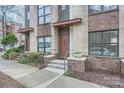 Townhome entry with brick facade, steps, and landscaping at 716 N Alexander St, Charlotte, NC 28202