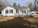 White Ranch home with deck and landscaping at 796 S Lincoln S St, Dallas, NC 28034