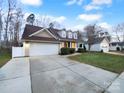 House exterior showing driveway and landscaping at 8249 Chatham Oaks Dr, Concord, NC 28027