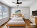 Virtually staged bedroom with hardwood floors and a ceiling fan at 8806 Glenside St, Huntersville, NC 28078