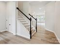 Elegant staircase featuring modern railing design and wood floors at 10121 Mamillion Dr, Huntersville, NC 28078
