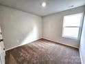 Simple bedroom with carpeted floors and a large window at 129 Lightning Dr, Shelby, NC 28152