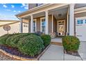 Charming front porch with brick columns and lush landscaping at 138 Byers Commons Dr, Mooresville, NC 28117