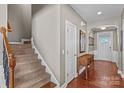 Elegant staircase with a wooden railing and carpeted steps at 138 Byers Commons Dr, Mooresville, NC 28117