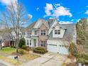 Two-story house with brick and siding exterior, two-car garage, and landscaping at 1458 Bedlington Nw Dr, Charlotte, NC 28269