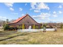 Wooden barn with red roof, and white chairs for an outdoor ceremony at 15554 Highway 601 S Hwy, Midland, NC 28107