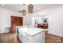 Open concept kitchen with island, farm sink, and view into dining area at 2002 Summey Ave # 4, Charlotte, NC 28205