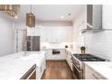 Bright kitchen boasts white cabinets, quartz countertops, and stainless steel appliances at 2002 Summey Ave # 4, Charlotte, NC 28205