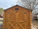 Wooden storage shed with double doors at 206 Barnyard Ln, Statesville, NC 28625