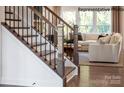 Elegant staircase with dark wood and metal railings, overlooking living room at 2173 Millennium Dr # 40, Lancaster, SC 29720