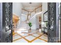 Two-story foyer with elegant staircase and marble flooring at 2510 Tulip Hill Dr, Charlotte, NC 28270