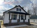 New construction home with white siding, black accents, and a brick base at 401 Fourth St, Stanley, NC 28164