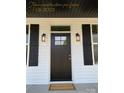 Modern front door with black finish and welcoming mat at 401 Fourth St, Stanley, NC 28164