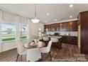 Bright breakfast nook with a round table and four chairs, adjacent to kitchen at 5008 Mooreland Oaks Way # 134P, Mount Holly, NC 28120