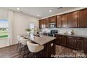 Modern kitchen featuring granite countertops and dark wood cabinetry at 5008 Mooreland Oaks Way # 134P, Mount Holly, NC 28120