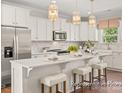 Spacious kitchen with white cabinets, large island, and stainless steel appliances at 5010 Mooreland Oaks Way # 1P, Mount Holly, NC 28120