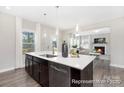Open concept kitchen with island, looking toward Gathering room at 5011 Mooreland Oaks Way # 3P, Mount Holly, NC 28120