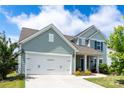 Charming two-story home with a well-manicured lawn, and a two car garage at 5034 Moselle Ave, Fort Mill, SC 29707