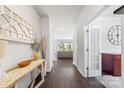 Bright foyer featuring hardwood floors, decorative mirror, table, and an open view to the living room at 5034 Moselle Ave, Fort Mill, SC 29707