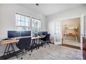Bright home office space featuring a long desk with monitors and two large windows with blinds at 5034 Moselle Ave, Fort Mill, SC 29707