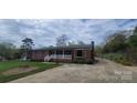 Brick ranch-style home with a covered front porch and long driveway at 5527 Dallas High Shoals Hwy Hwy, Dallas, NC 28034
