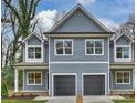 Symmetrical duplex exterior boasts gray siding, white trim, and matching garage doors at 625 Colorado Ave # A, Charlotte, NC 28206