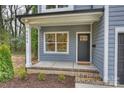 Inviting porch with gray siding, brick accents, and a well-manicured lawn at 625 Colorado Ave # A, Charlotte, NC 28206