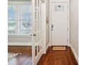 Bright foyer with hardwood floors, white trim, and a glimpse into the living room at 746 Waterscape Ct, Rock Hill, SC 29730