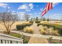 Manicured front garden featuring trimmed hedges and a brick walkway at 746 Waterscape Ct, Rock Hill, SC 29730