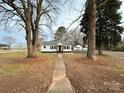 Charming white house with brown shutters, walkway, and landscaping at 810 8Th Avenue Ext, Cramerton, NC 28032