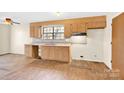 Galley kitchen with wood cabinets and laminate floors at 115 E Geroid St, Salisbury, NC 28144