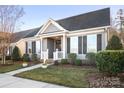 Beautifully landscaped yard and welcoming front porch offer curb appeal to this single-story home at 11508 Dublin Crescent Rd, Cornelius, NC 28031