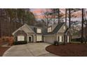 Inviting home with stone accents, manicured landscaping, and a long driveway surrounded by mature trees at 117 Cove Pointe, Mount Holly, NC 28120