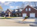 Townhome community featuring brick exteriors, 2-car garages, and lush landscaping at 121 Quality Dr, Mount Holly, NC 28120