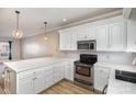 Modern kitchen with white cabinets, quartz countertops, and stainless steel appliances at 121 Quality Dr, Mount Holly, NC 28120