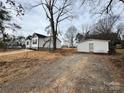 White house with detached garage and partially cleared lot at 1307 Signal Ave, Gastonia, NC 28052