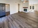 Open living area with hardwood floors and fireplace at 13943 Dannemara Dr, Pineville, NC 28134