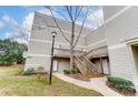 Tan siding condo building with stairs and small yard at 1605 Merry Oaks Rd # E, Charlotte, NC 28205