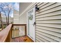 Condo front door with wooden deck and wreath at 1605 Merry Oaks Rd # E, Charlotte, NC 28205