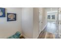 Bright hallway with teal bench and doors to other rooms at 3021 Belstock Ct, Charlotte, NC 28216